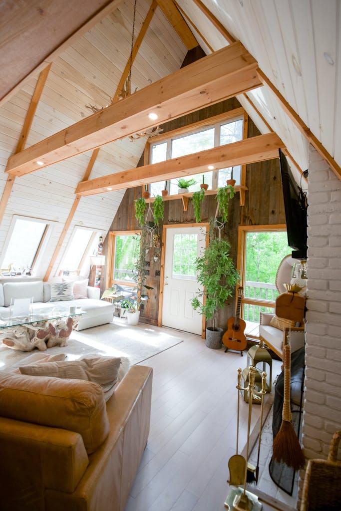 Brightly lit chalet interior with natural wood and boho decor emphasizing cozy home feeling.